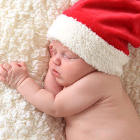 Christmas baby wearing a Santa hat