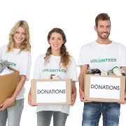 Portrait of three smiling young people with donation boxes over white background