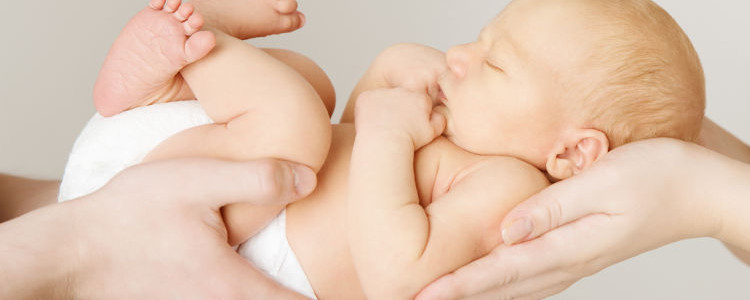 baby newborn sleeping on parents hands, kid and family concept